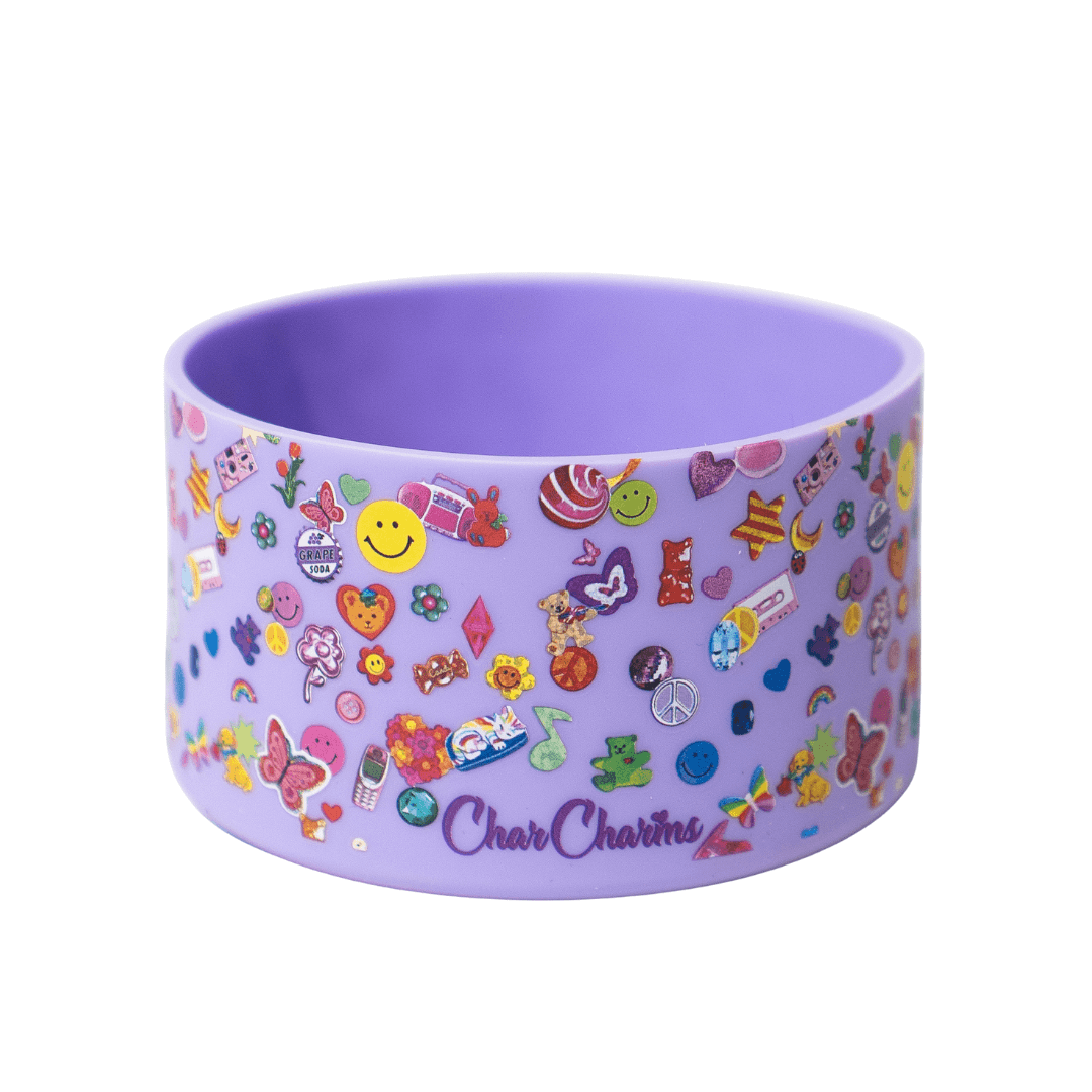 Close-up of a purple sticker-covered tumbler boot with fun character designs and hydration charm