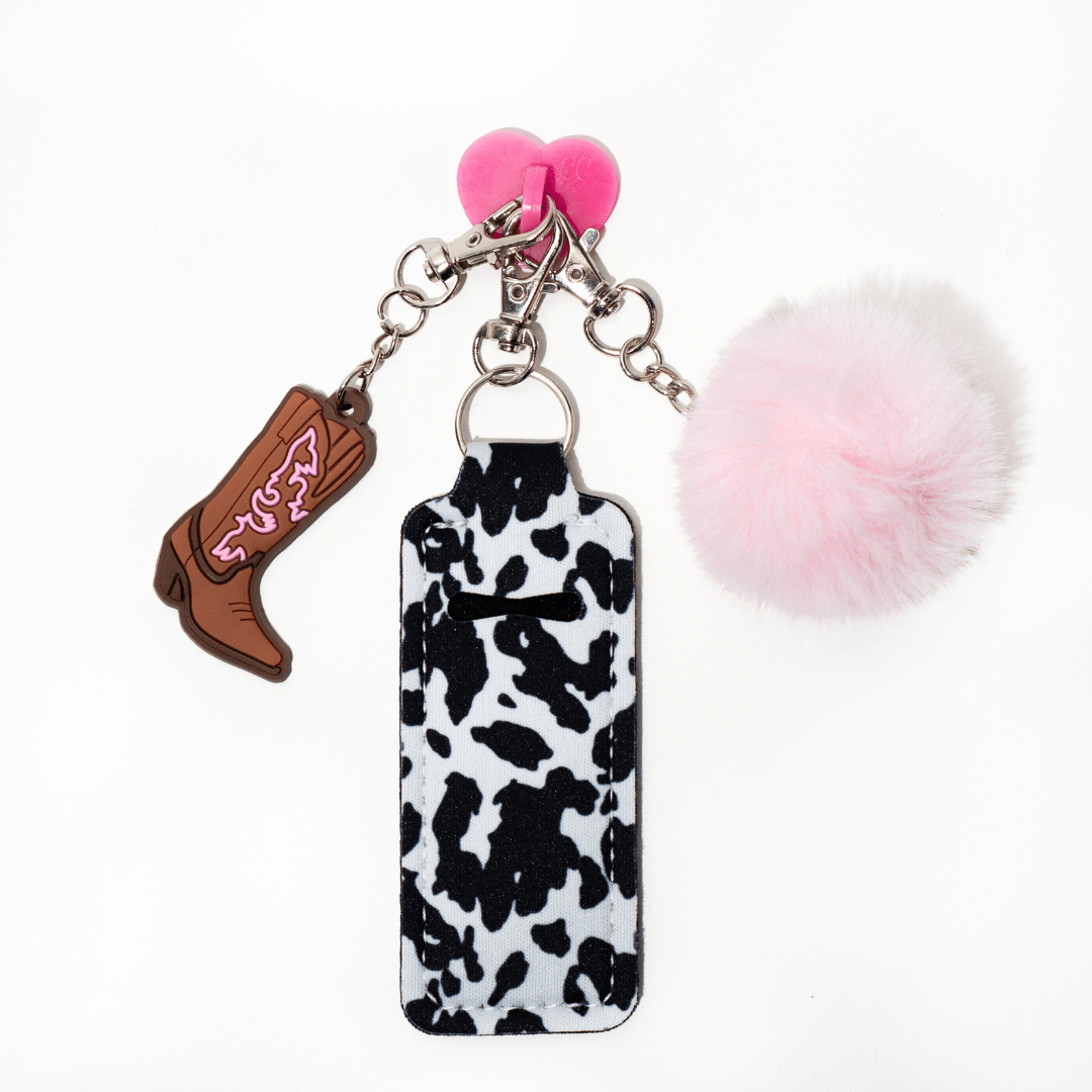 Close-up of pink pom-pom and cow print chapstick holder