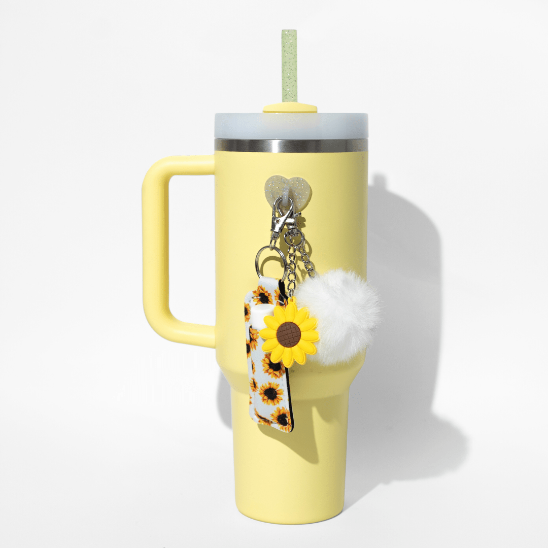 Sunflower and lemon bottle charms on white background