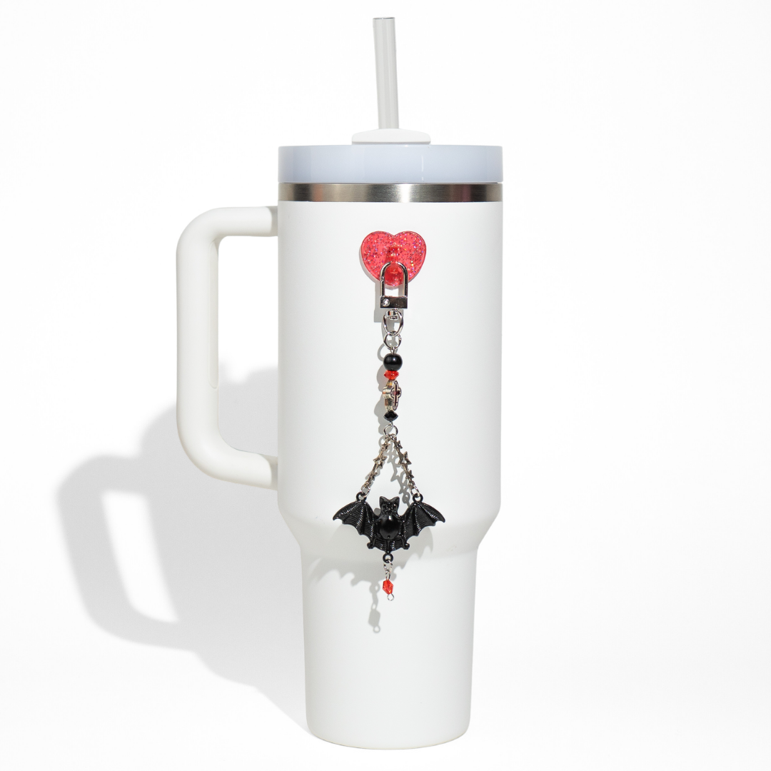 White tumbler featuring a bat bottle charm set with red heart clip and black accents from CharCharms