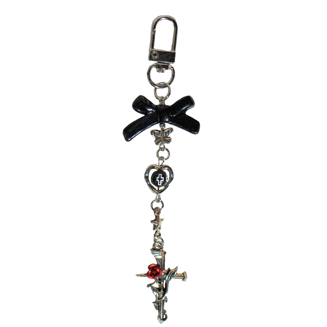 CharCharms gothic bottle charm featuring black bow, silver cross with red rose, and heart pendant on a white background