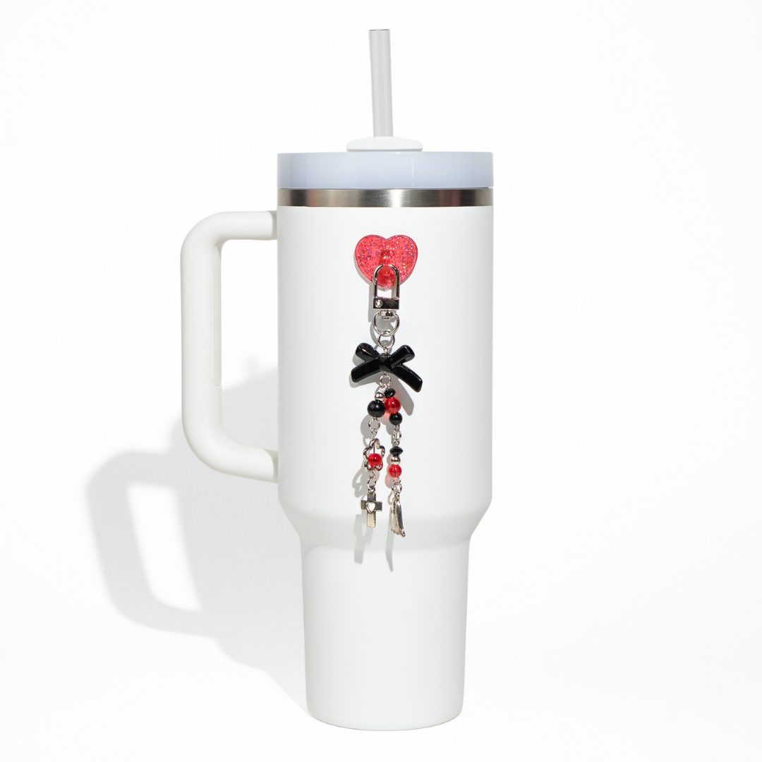 White tumbler featuring a red glitter heart clip with black bow and silver charm chain from CharCharms