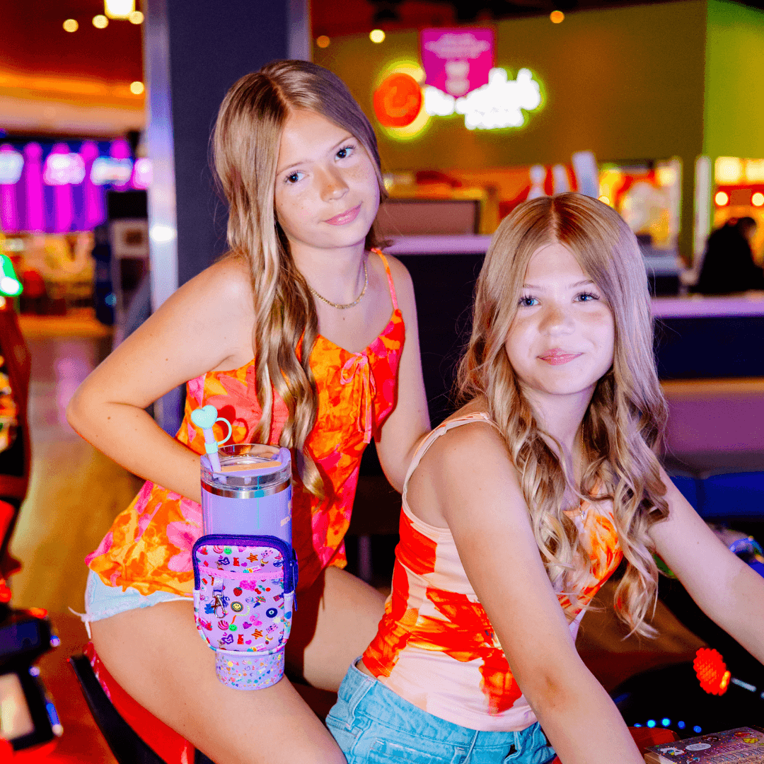 Girl with green bowling ball and purple tumbler decorated with heart topper and pouch, perfect for back to school