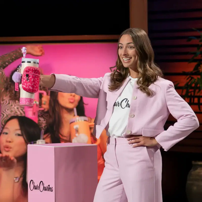 CharCharms founder presenting hydration bottle charms on Shark Tank stage with pink branding